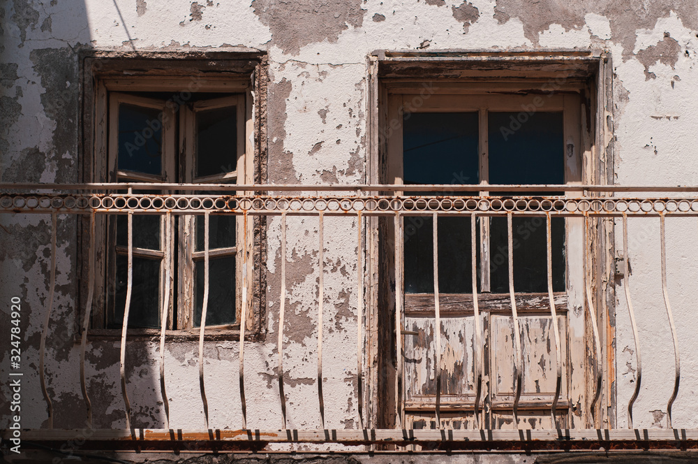 Facade of an old building with wooden windows and a balcony. The streets of the resort town of Turkey Bodrum. Facade of an old building with wooden windows and a balcony. The streets of the resort town of Turkey Bodrum.
