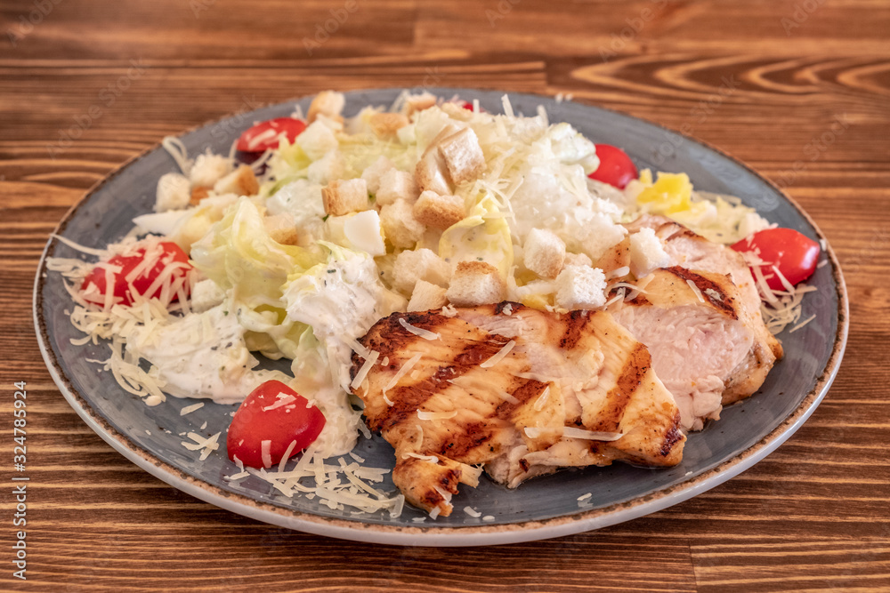 Caesar salad with roasted chicken and tomatoes. Caesar salad with roasted chicken and tomatoes.