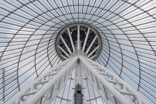 Giant metall colums holding a top of giant conic roof construction. Frame of unusual roof construction.