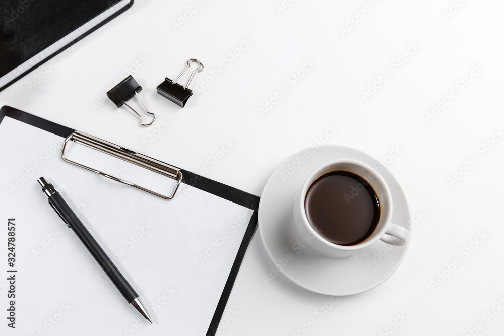 black office tablet with pen with coffee Cup with flower top view on white background. Space for text