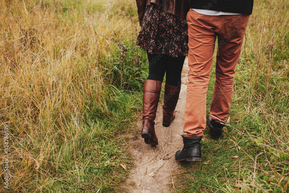 The couple hugs in the autumn on a walk. Back view The couple hugs in the autumn on a walk. Back view