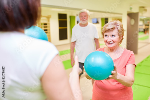 Trainer und Senior Frau mit einem kleinen Gymnastikball