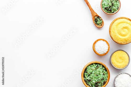 Spa cosmetics. Set of salt in bowls on white wooden background top-down frame copy space