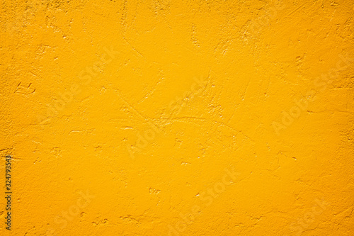 Gold paint patterns or dark orange texture concrete wall for yellow colorful bright background