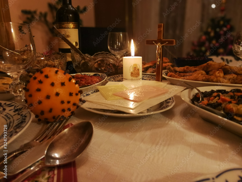 Lithuanian Christmas Eve table with Christmas wafers, candle and various dishes