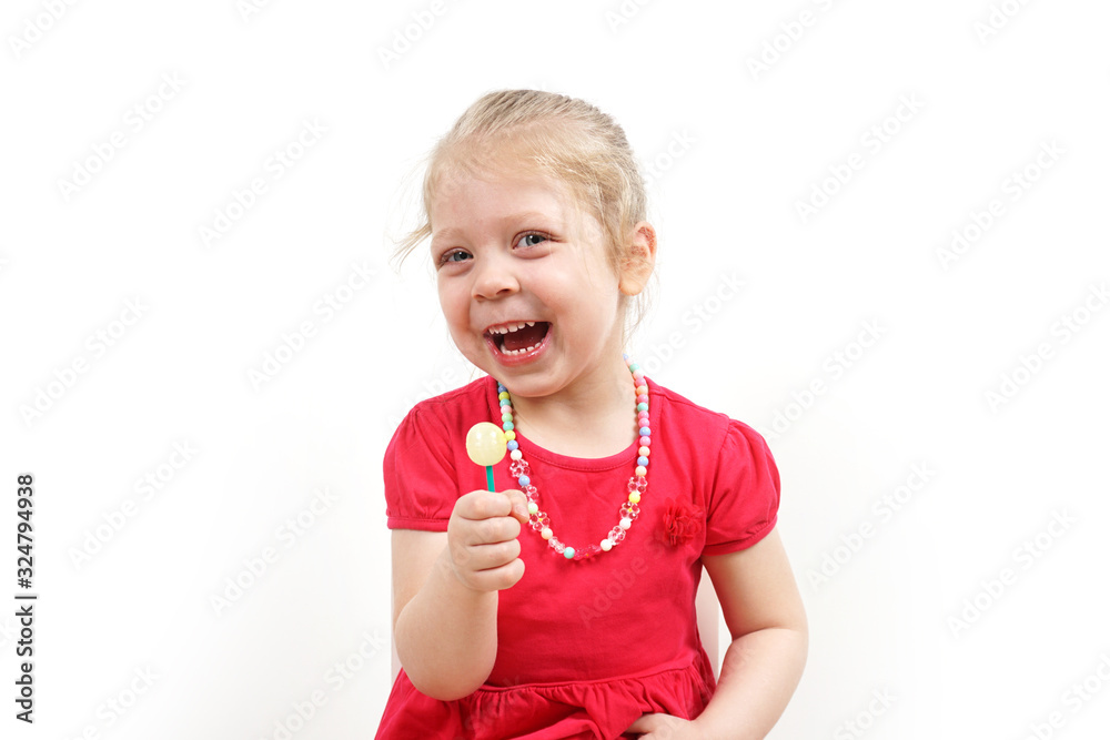 Cheerful little blonde girl in a pink dress for advertising. Lollipop in the hands. Cheerful little blonde girl in a pink dress for advertising. Lollipop in the hands.