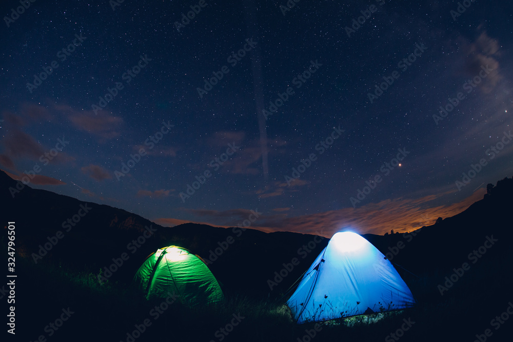 Tents in the night with the milky way.  Wanderlust and travel concept. 