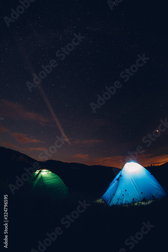 Tents in the night with the milky way. Wanderlust and travel concept. 