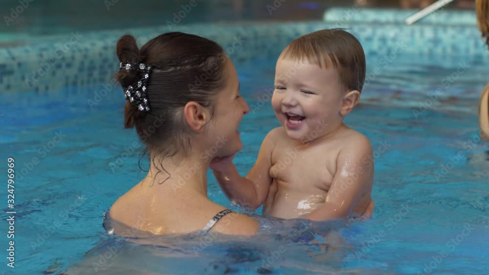Laughing boy with mother in the pool Laughing boy with mother in the pool