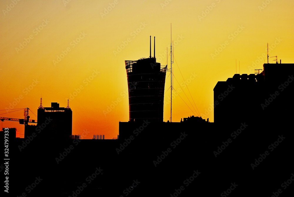 City in silhouette during sunset