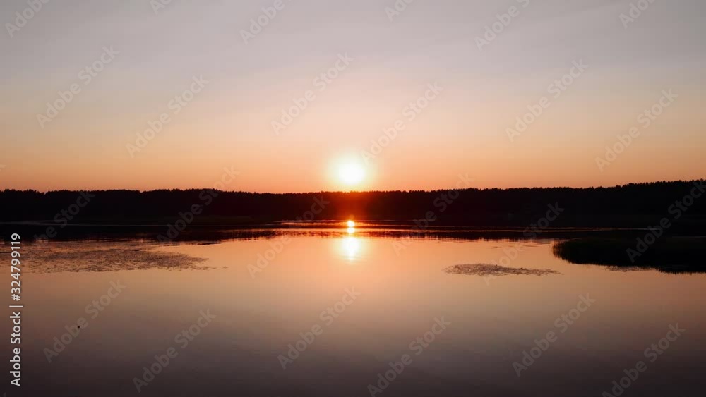 Sunset aerial view during hot summer day in Northern Europe with reflection on the lake Sunset aerial view during hot summer day in Northern Europe with reflection on the lake