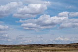Kazakh steppe with cloudy sky background.