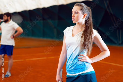 Young woman playing tennis at indoor tennis court © fotofabrika