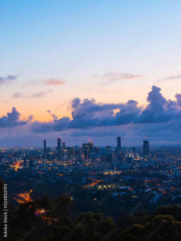 Brisbane skyline view at dawn with cloudy sky.
