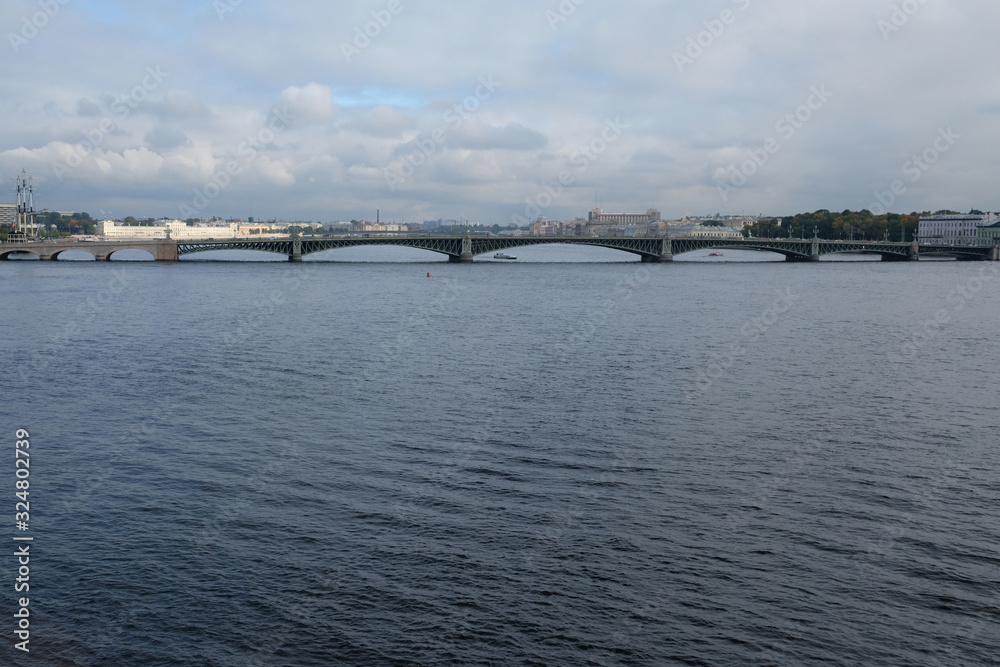 Neva river and Trinity bridge with cloudy sky background.