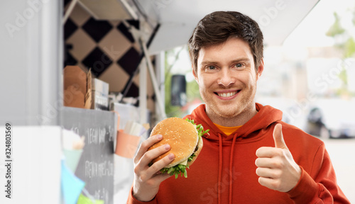 Cuadro en lienzo fast food, takeaway and people concept - happy smiling young man in red hoodie w