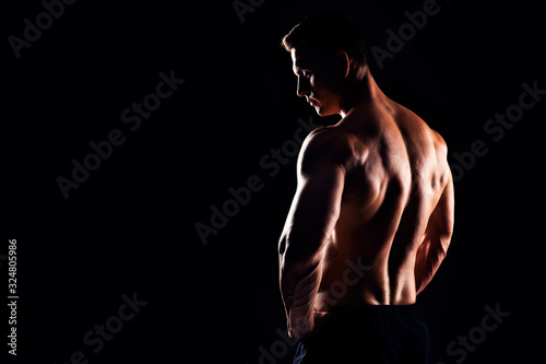 Bild auf Leinwand Strong, fit and sporty bodybuilder man over black background.