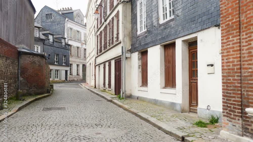HONFLEUR, FRANCE - APRIL 08, 2018: view of empty beautiful street with old traditional houses at the center of Honfleur, Normandy, France HONFLEUR, FRANCE - APRIL 08, 2018: view of empty beautiful street with old traditional houses at the center of Honfleur, Normandy, France