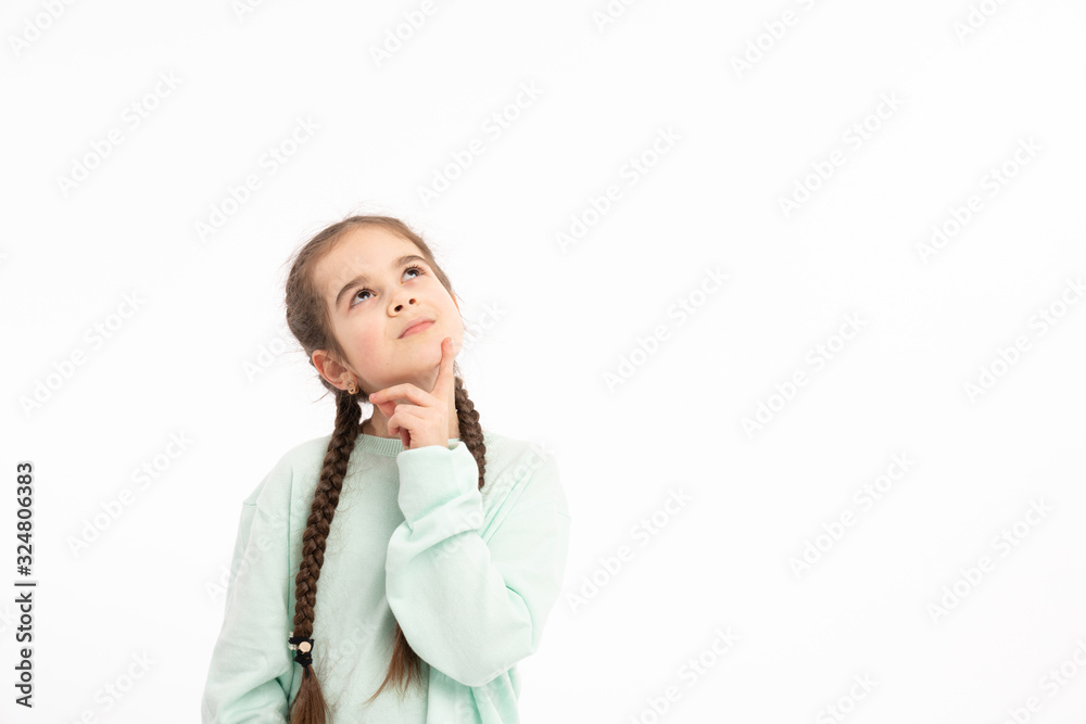 Horizontal portrait of thoughtful puzzled youngster looks with pensive dreamy expression aside, thinks what decision to make, stands against white background Horizontal portrait of thoughtful puzzled youngster looks with pensive dreamy expression aside, thinks what decision to make, stands against white background