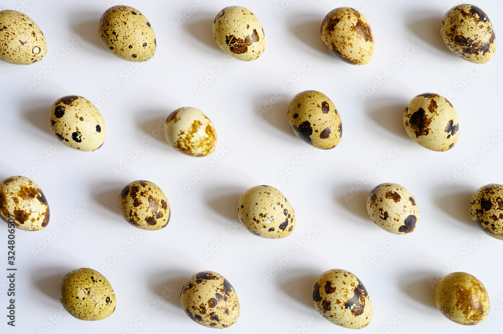 quail eggs on a white background. a regular pattern
