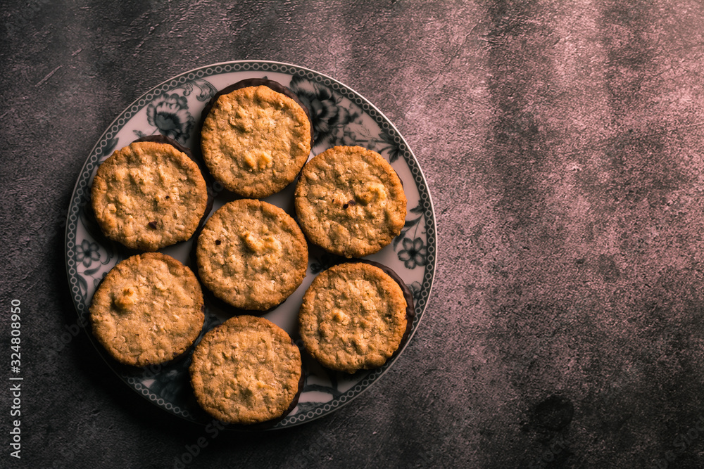 Seven delicious cookies on a plate decorated with flowers. Aerial View Horizontal format Seven delicious cookies on a plate decorated with flowers. Aerial View Horizontal format