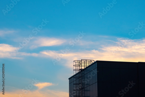 Fire escape ladder with sky background.