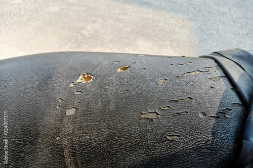 Artificial leather black broken pattern texture ,Black motorcycle old seats torn.