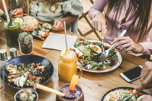 Canvas Print Hands view of young people eating brunch and drinking smoothies bowl with ecolog