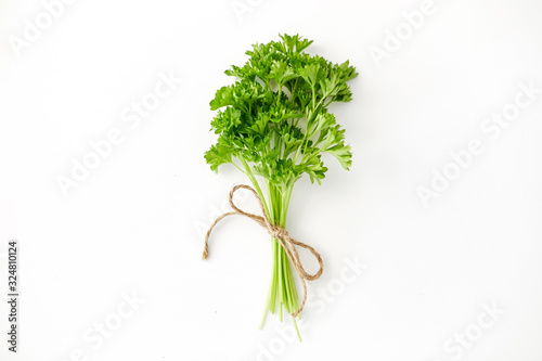 greens, culinary and ethnoscience concept - bunch of parsley on white background photo