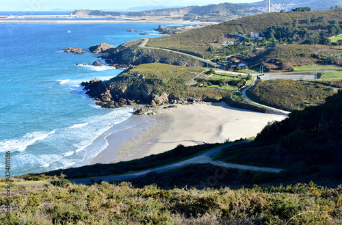 Beach with cliff and industrial port. Arteixo, Coruña, Galicia, Spain. photo