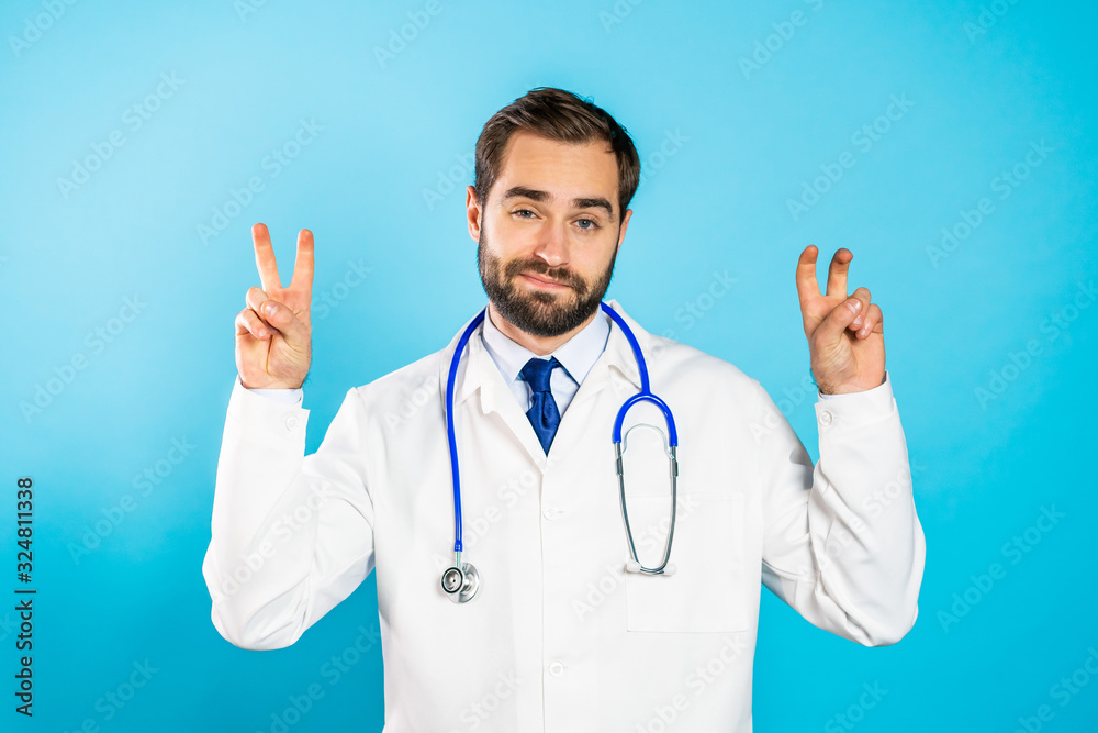 Doctor man with beard showing with hands and two fingers like quotes gesture, bend fingers isolated over blue background. Very funny, irony and sarcasm concept. Doctor man with beard showing with hands and two fingers like quotes gesture, bend fingers isolated over blue background. Very funny, irony and sarcasm concept.