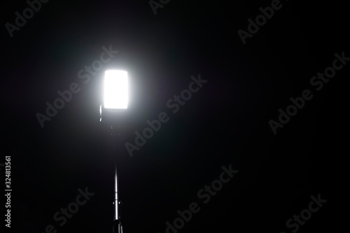 Street light on a black background. Street lamp in the darkness.