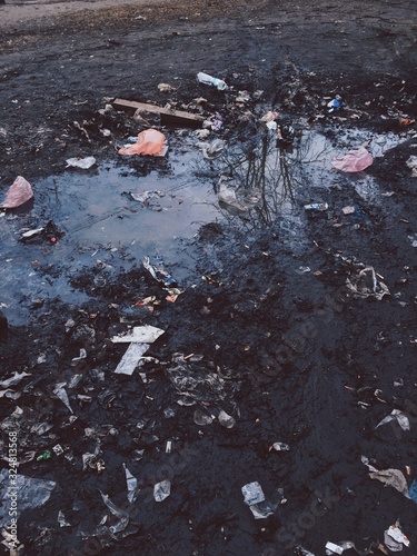  Puddle with quarrel on the street. Environmental pollution