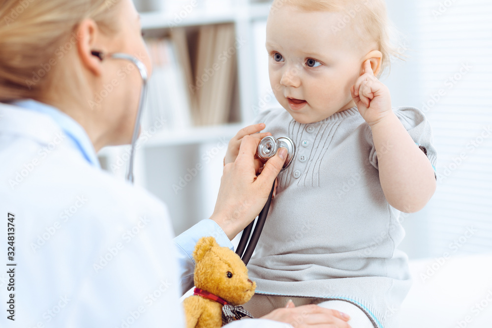 Doctor and patient in hospital. Little girl is being examined by doctor with stethoscope. Medicine concept Doctor and patient in hospital. Little girl is being examined by doctor with stethoscope. Medicine concept