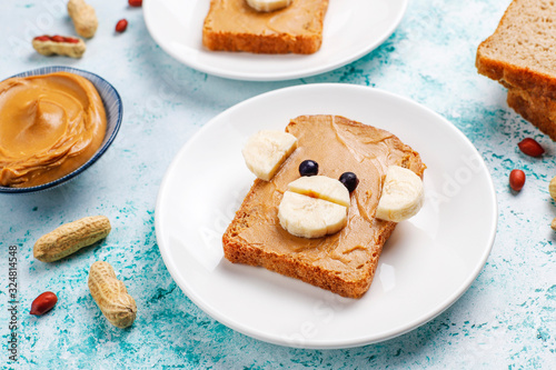 Photography Funny bear and monkey face sandwich with peanut butter, banana and black currant