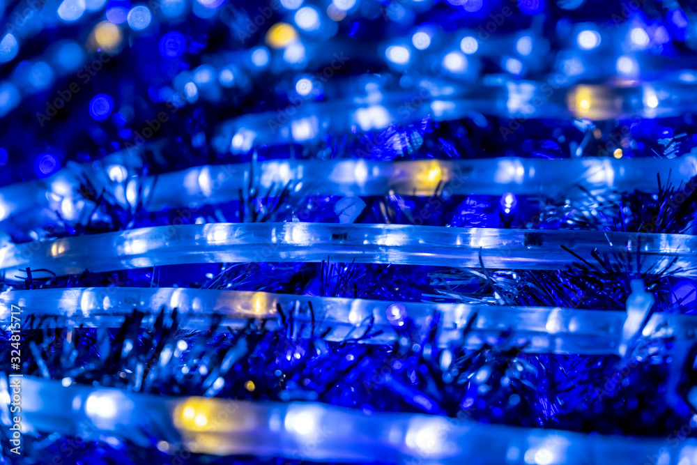 Christmas decorations with lights garland and tinsel at night, selective focus. Christmas decorations with lights garland and tinsel at night, selective focus.