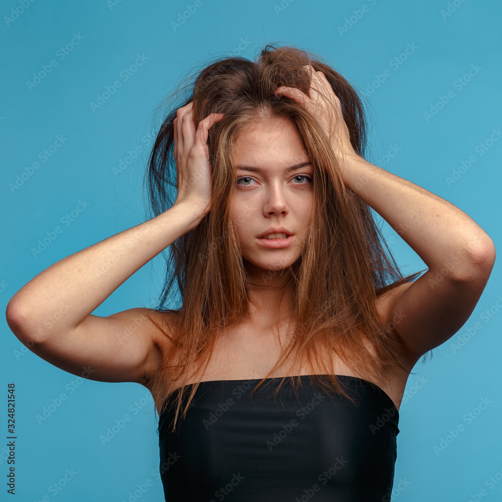 emotional portrait of a young attractive girl. Studio shooting, blue background emotional portrait of a young attractive girl. Studio shooting, blue background