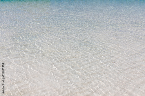 Beautiful shallow sea water. Sunny beach weather  calm sea waves  surf