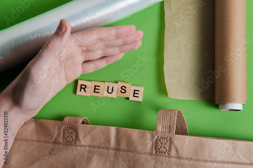 reduce, reuse and recycle word in vintage wooden letterpress type blocks, flatlay on green font