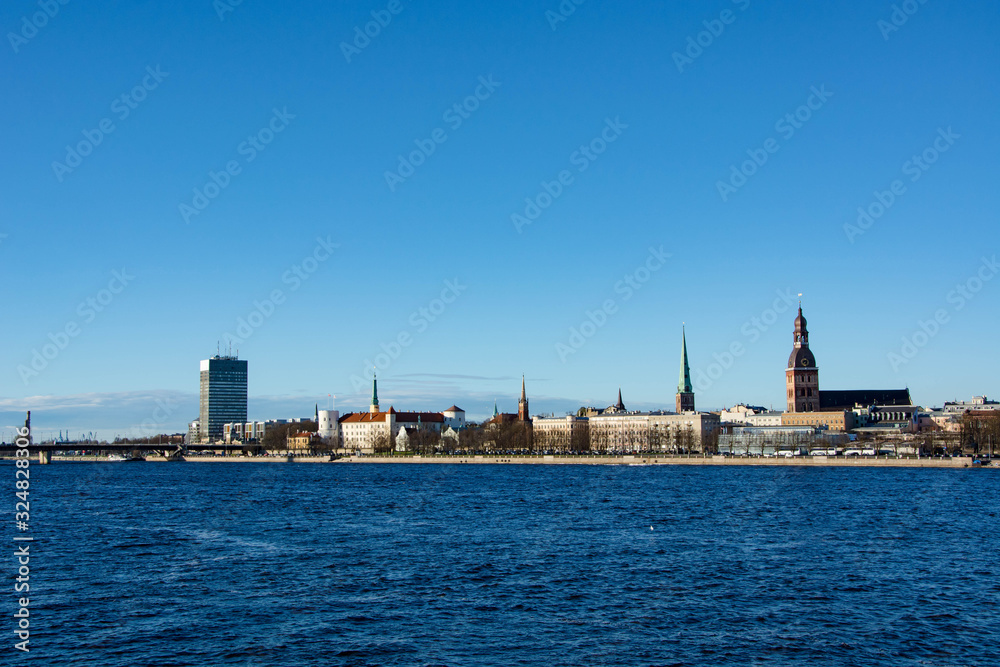 Sunny day at Riga, Latvia. Panorama of the city. Daugava river. Dome cathedral.