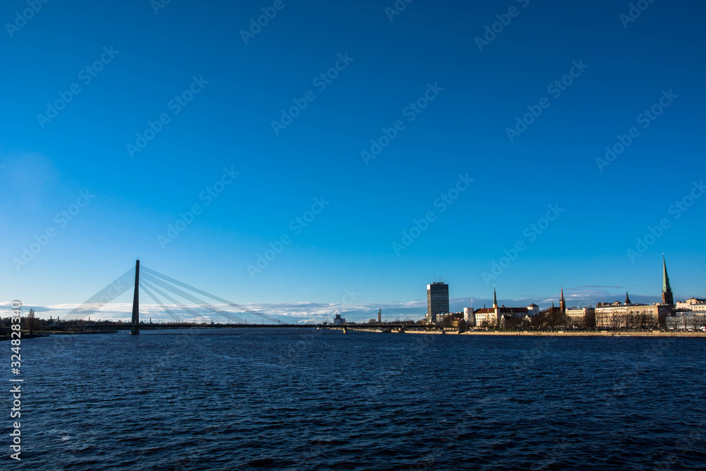 Sunny day at Riga, Latvia. Panorama of the city. Th bridge over the Daugava river.