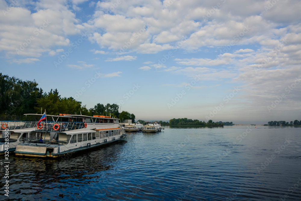Volga river in Russia. Cloudy summer weather. River port. Ship parking.