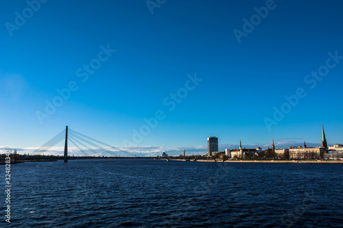 Sunny day at Riga, Latvia. Panorama of the city. Th bridge over the Daugava river.