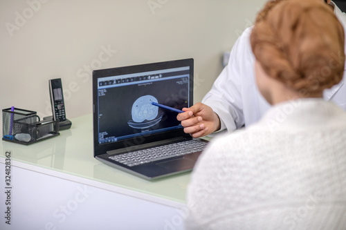 Male doctor showing investigation results to the patient