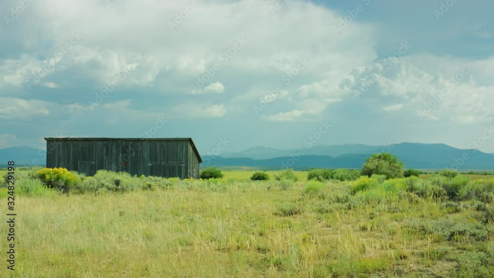 Static shot of an old barn with storm clouds in the distance. Static shot of an old barn with storm clouds in the distance.