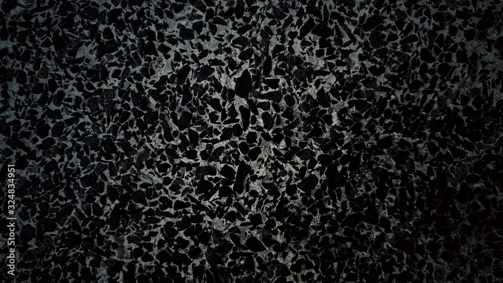 Black background of small pieces of stones embedded in cement Black background of small pieces of stones embedded in cement