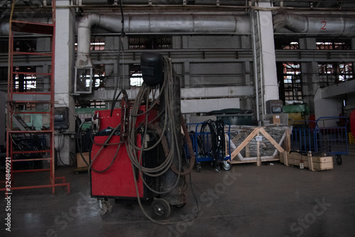 Remote control for heat treatment of welded joints. The welder works as a welding machine. Welding fittings and reinforcing mesh. Industrial interior. Plant