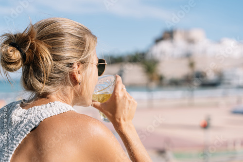 girl looking at peniscola city, in spain with copyspace photo
