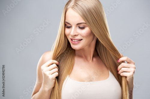 Beauty portrait of young woman with healthy skin and soft natural make up. Spa and care. Long beautiful blonde hair