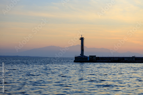 lighthouse at sea at sunset